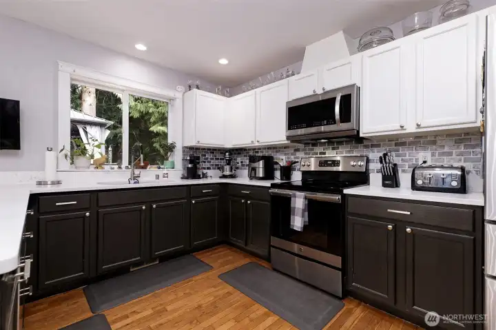 Very striking kitchen with granite counters and tile backsplash. And REAL hardwood floors!