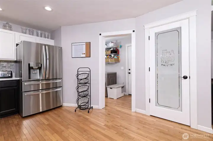 Main floor kitchen with a nice pantry, leading into the utility room, and, beyond that, the door to the garage.