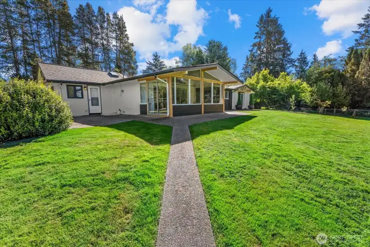 View of the back of home with the sunroom area which faces the road as you drive up