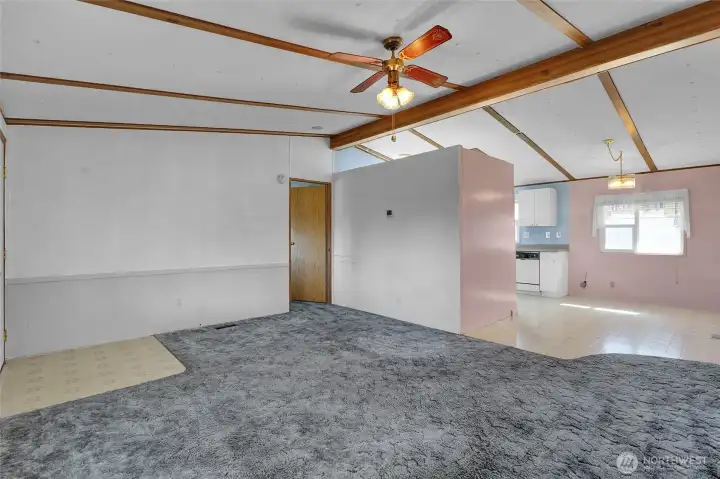 Front door to the left, and primary bedroom through that door on the far wall.  The dining room is where the vinyl flooring is. And you'll enjoy the ceiling fan summer or winter.