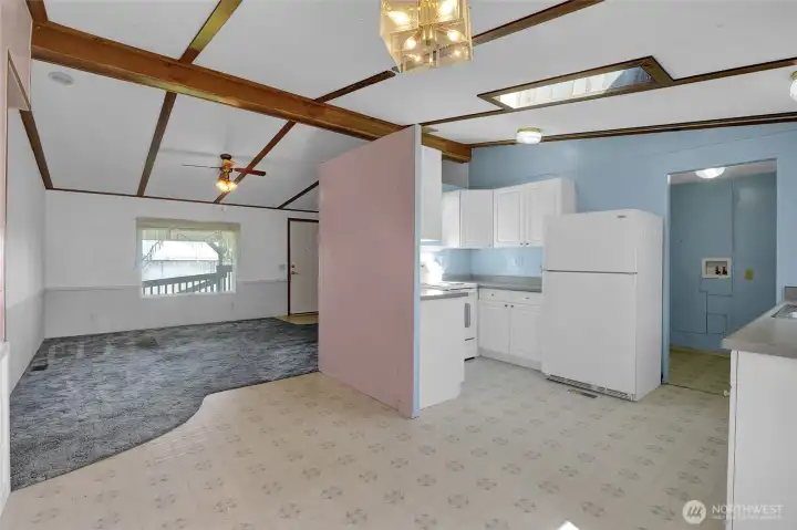 As you come into the dining room and kitchen, you'll notice the ceiling lights and skylight for plenty of natural light.