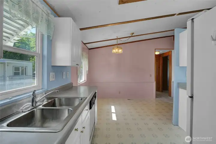 Behind you is the utility room.  You'll want to plan ahead to pick up a washer and dryer when you move in here.