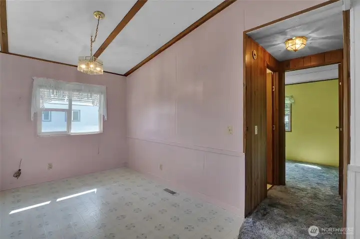 From the dining room, you can see the doorways of the main bathroom and second bedroom.