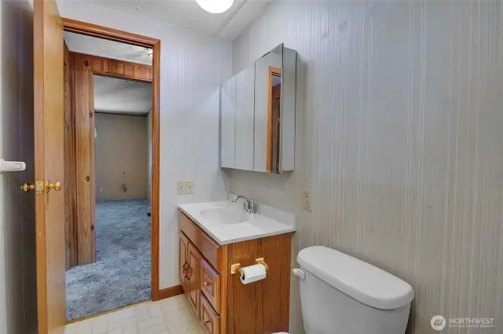 From the main bathroom, you can see into one of the bedrooms.