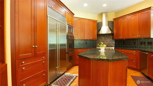 Kitchen has lots of built-in cabinets for storage, Granite Slab Counter tops and Island,and  Breakfast Counter
