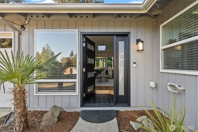 Step through the sleek modern front door and into a light-filled space with updated windows—welcome to effortless one-story living!