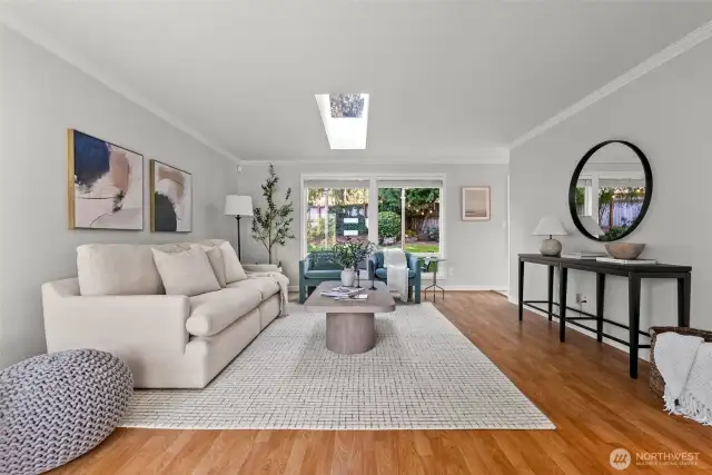 Skylights, expansive windows, and an open-concept living room create a warm and inviting atmosphere!