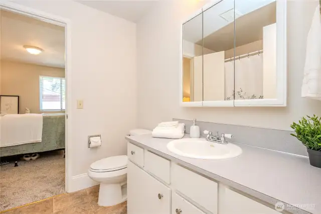 Looking through the Hall Bathroom you see the doorway into Bedroom #2.