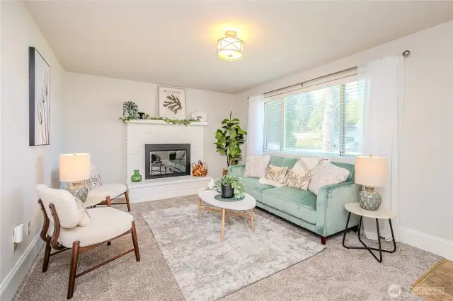 Just inside the front door you find the Living Room with cozy wood burning fireplace & large picture window offering great natural light and views of the front yard and quiet 6th Avenue.