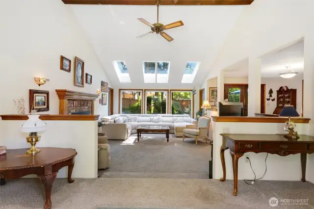 Front living room with fireplace and windows to the fully fenced yard.