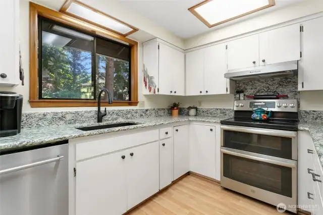 Updated kitchen with granite countertops, double oven, stainless farm house sink.