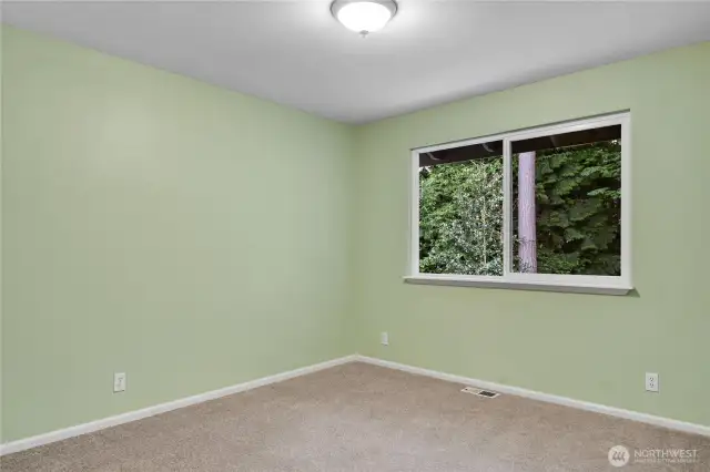 East bedroom. Paneled Quaker door. New carpet. Closet with raised-panel bi-fold Quaker-style doors. South-facing window with window screen overlooks Park below.