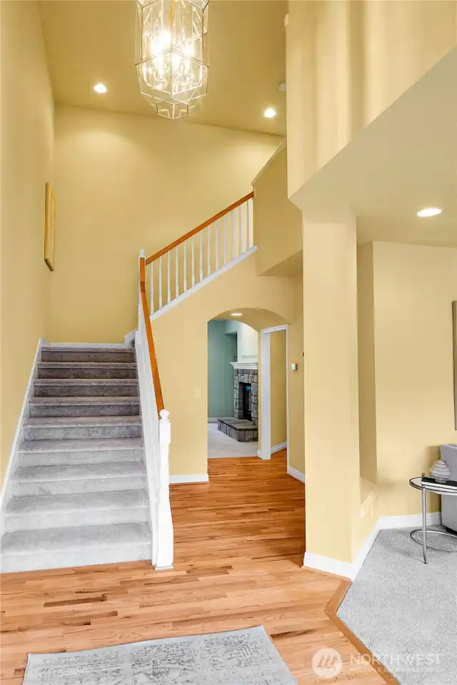 Entry interior. Magnificent foyer with soaring ceiling, polished-brass and beveled glass pendant chandelier. Oak-hardwood floor. Signature William Buchan millwork throughout. Entry hall with barrel-shaped passageway and entry coat closet with storage area behind. Newer Trane® digital thermostat.
