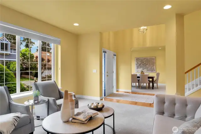 Living room off entry. Traditional divided-light windows with window screens and two-inch blinds. 9-ft high ceiling with additional accent lighting. Dining room across from Living room.