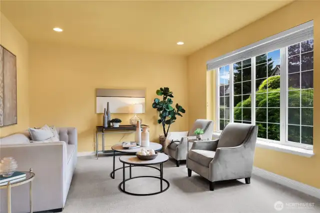 Living room off entry. Traditional divided-light windows with window screens and two-inch blinds. 9-ft high ceiling with additional accent lighting.