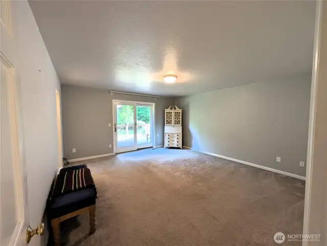 Primary Bedroom with 2 claosets. with door accessing the deck #2835 Cooper Point Rd NW, Olympia, WA 98502