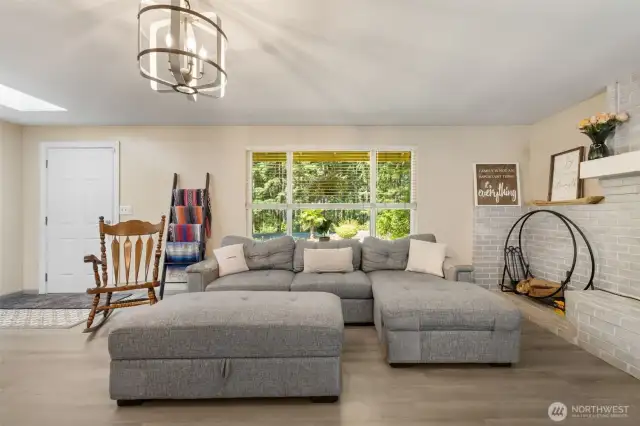 Comfort meets character in the light-filled living room—ideal for gathering, relaxing, or simply enjoying the view out front.