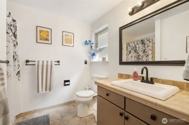 Fresh finishes and a clean, functional layout make the primary bath both stylish and practical.