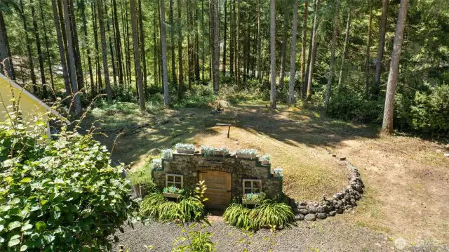 Tucked beneath the earth like a secret, this hobbit-style wine cellar is as charming as it is cleverly crafted.