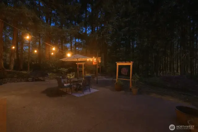 As evening settles in, the patio transforms—market lights glow, laughter lingers, and the day ends just right. (image digitally enhanced to simulate dusk conditions)