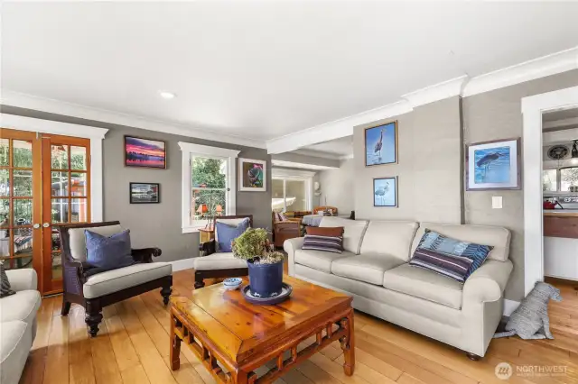 To the far right is the dining area and to the left are french doors that lead out to the perfect little sun room.