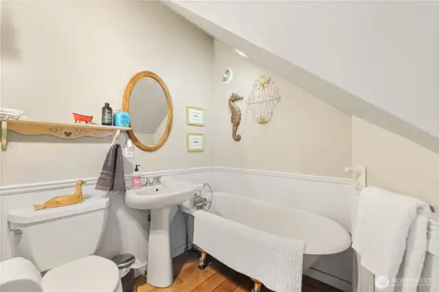 The ADU bath blends contemporary style with timeless charm, featuring sleek finishes alongside a classic clawfoot tub with a handheld shower.