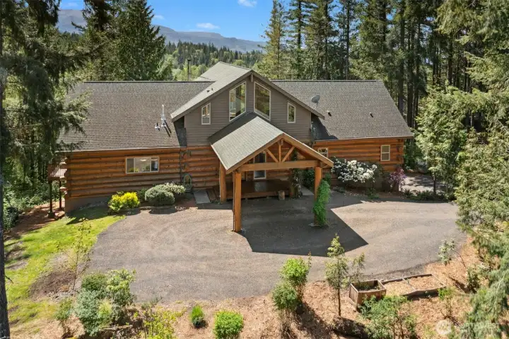 Exquisite log cabin home sitting on two tax lots, totaling 5.68 acres, with 200+' of waterfront on Winters Lake