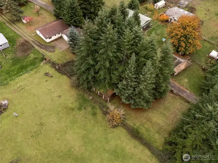 The long, 2.38 acre parcel combines privacy with open spaces plus an RV height car-port, some open pasture, sunny garden spaces, and woods for trails.