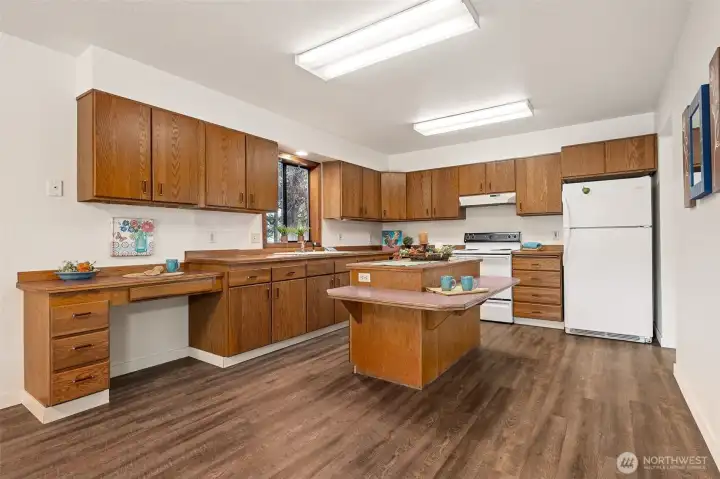The welcoming kitchen has a special built-in chair height eating counter attached to the island for "lunch-counter"  style dining.  The convenient desk/work station makes a great landing spot for phone charges, laptops, or mail.