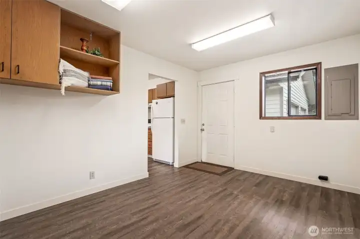 The back entry door off the kitchen/utility room leads directly to the detached garage and back acres.  Design a boot bench and coat hooks on this side of the room and keep the raincoats and mud boots contained here!