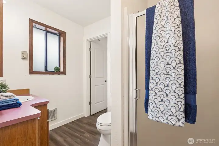 A shower with glass door is included in the bathroom off the primary bedroom which is also accessed from the utility/mud room space.