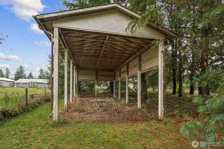 The covered RV parking shed has not been used for some time but awaits a little mowing and refreshing.