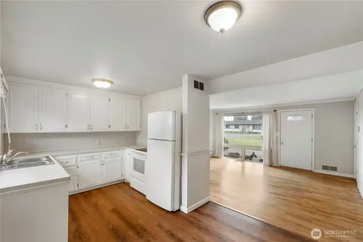From Dining Room looking into U shaped Kitchen on the left and Living room/entry on the right