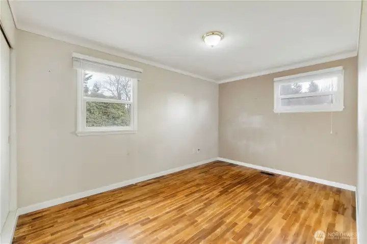 Primary Bedroom with Hardwood floors and long sliding closet doors on the far left