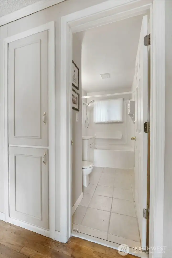 Towel pantry on the left leading into full bathroom