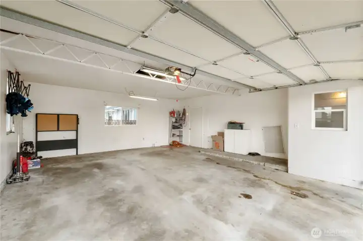 Large 2 car garage with back door leading to 2nd covered patio