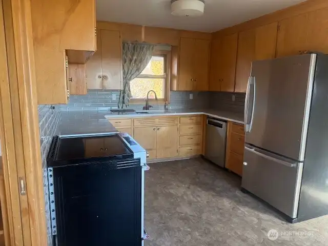 Updated kitchen, newer appliances, newer flooring and solid surface counters