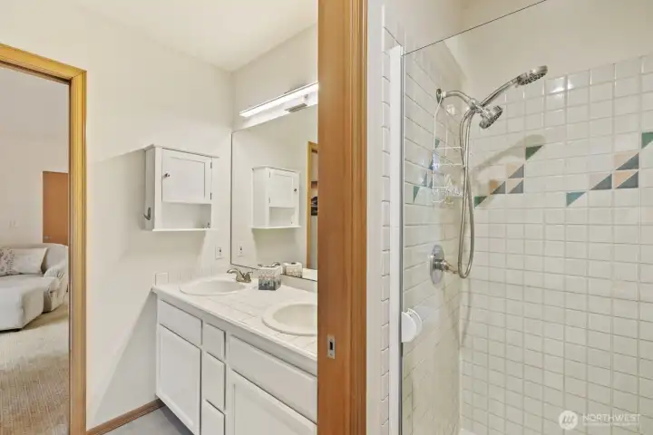 Dual vanities, a jetted soaking tub, and a glass walk-in shower - the perfect place to put on a fresh face for the day.