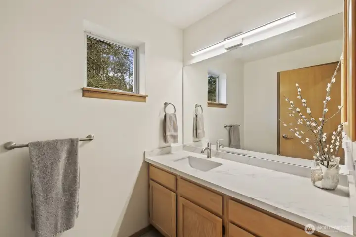 Upstairs hall bath has a tub and shower and lots of counter space.