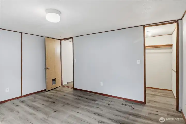 Second bedroom with walk-in-closet, looking back to the hallway.