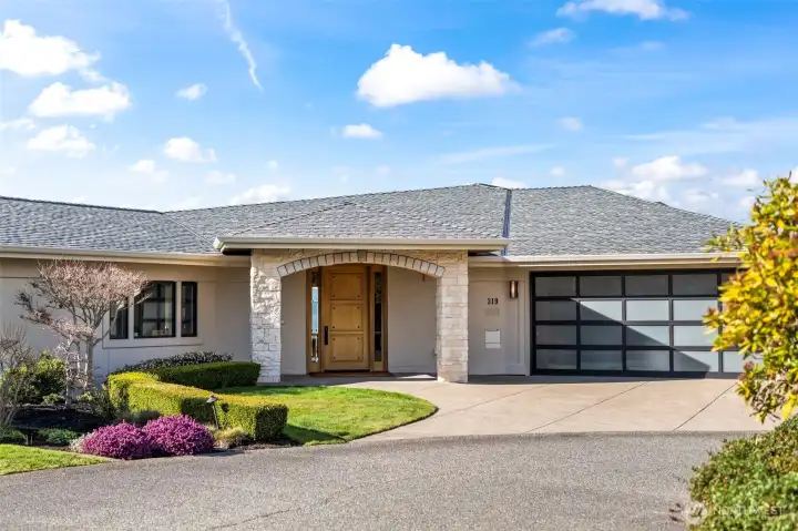 Framed by gorgeous landscaping, the stone masonry and winding drive evoke the feeling of a private European manor in the heart of the Pacific Northwest