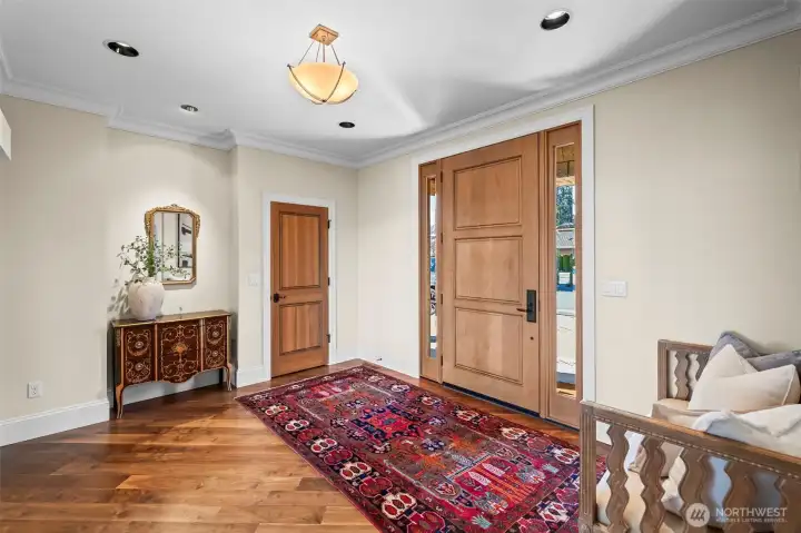 Rich walnut hardwoods underfoot provide a warm, sophisticated foundation that flows seamlessly into the home’s expansive living spaces straight from the foyer.