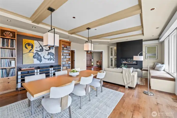 This expansive perspective showcases the seamless flow between the living and dining areas, where the walnut floors and floor-to-ceiling glass create a harmonious, light-filled environment.