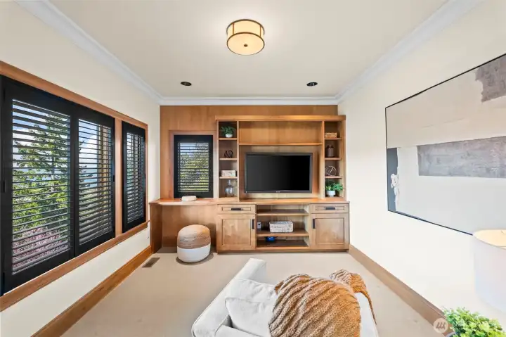 Tucked away from the home’s main social hub, this secondary living room offers a peaceful retreat for relaxation, characterized by the same high-end finishes and architectural volume found throughout the home.