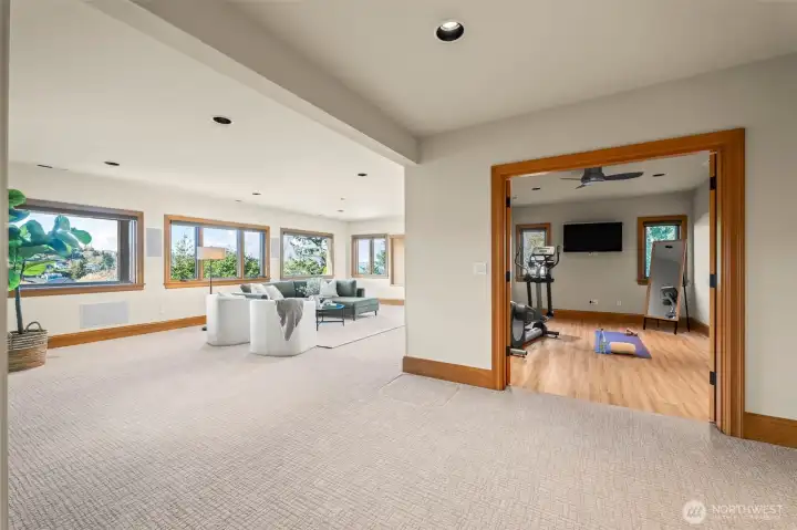 This expansive lower level offers a versatile bonus room for casual gatherings alongside a dedicated private workout studio, ensuring every lifestyle need is met with luxury.