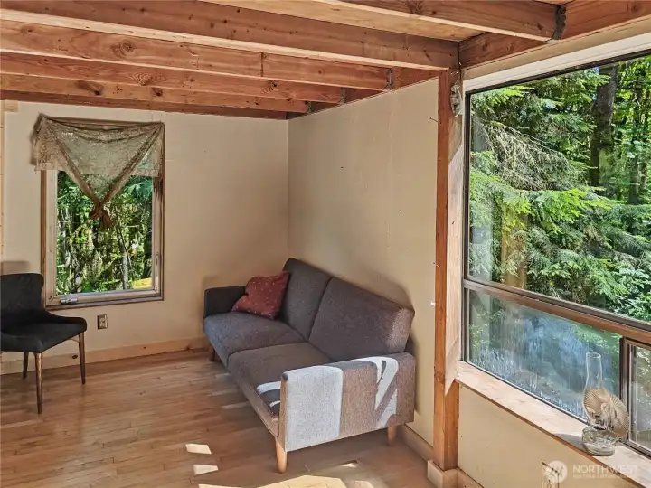 Living room with a view of the creek bed beyond.