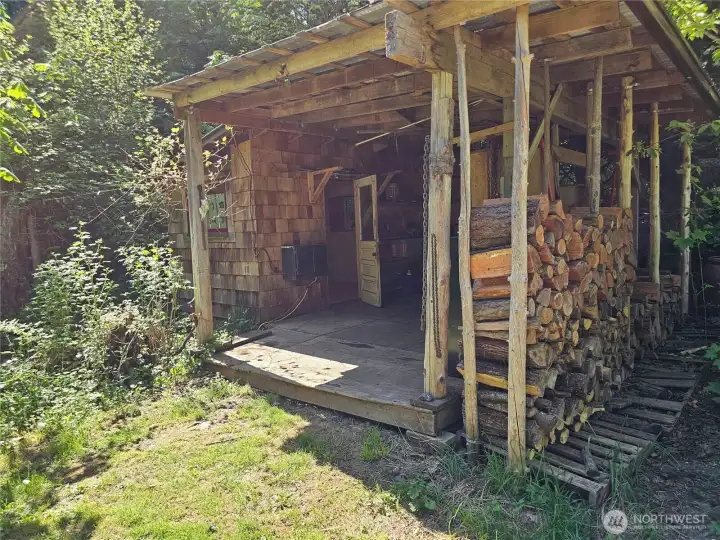 Just a little ways down the lane, this has historically been the workshop. Firewood and garden tool storage as well as a sweet little wood heated space inside.