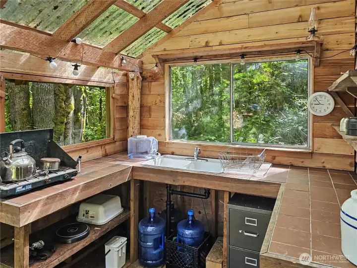 Half enclosed kitchen on the porch and views into the trees. Every cabin is extremely private and well placed.