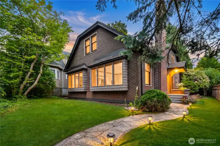 Nestled on a tree-lined street, this timeless Tudor in Magnolia blends classic character with generous living spaces and exceptional natural light. Perfectly positioned with coveted southern exposure, the home is filled with sunshine throughout the day, highlighting its rich architectural details, warm hardwood floors, and inviting living spaces.