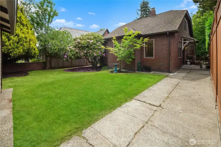 Outside, enjoy a private backyard retreat surrounded by mature landscaping, offering room to relax, garden, or entertain. A detached one-car garage is conveniently accessed from the rear of the property. Combining timeless Tudor charm and flexible living spaces, this special home presents an outstanding opportunity to make it your own.